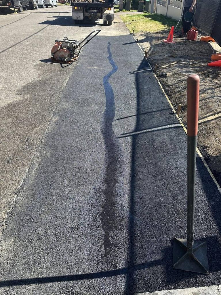 Hot-mix asphalt patch repair along a road edge